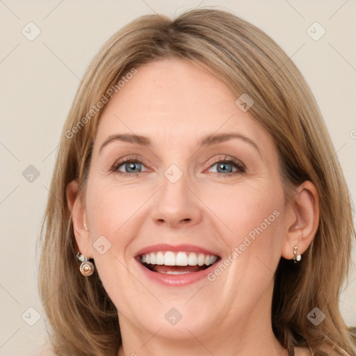 Joyful white young-adult female with long  brown hair and green eyes