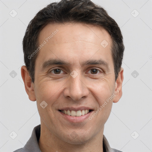 Joyful white adult male with short  brown hair and brown eyes