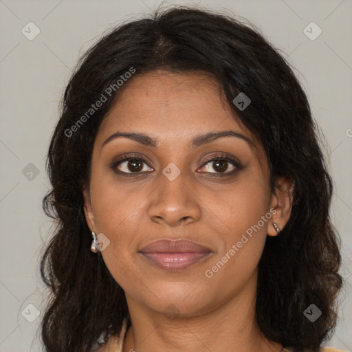 Joyful black young-adult female with long  brown hair and brown eyes