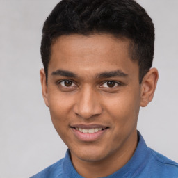 Joyful latino young-adult male with short  brown hair and brown eyes