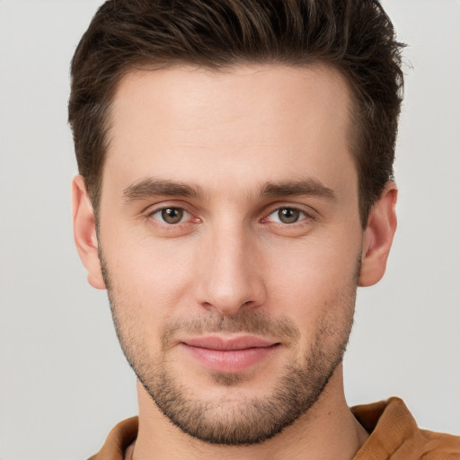 Joyful white young-adult male with short  brown hair and brown eyes