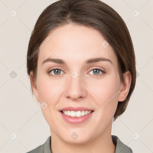 Joyful white young-adult female with medium  brown hair and grey eyes