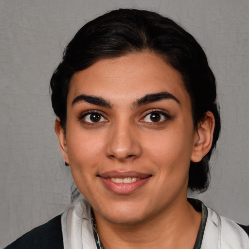 Joyful white young-adult female with short  black hair and brown eyes