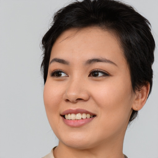 Joyful asian young-adult female with medium  black hair and brown eyes