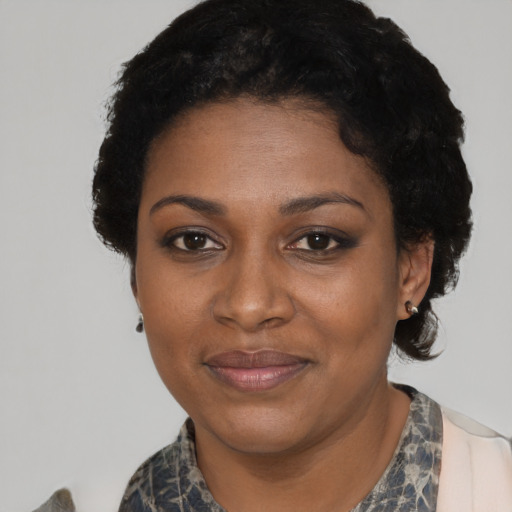 Joyful black adult female with short  black hair and brown eyes