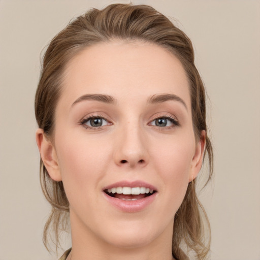 Joyful white young-adult female with medium  brown hair and grey eyes