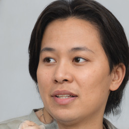 Joyful asian young-adult female with medium  brown hair and brown eyes