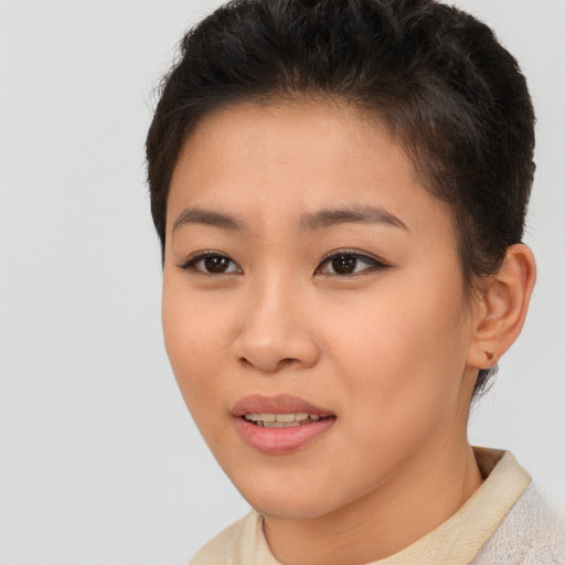 Joyful asian young-adult female with short  brown hair and brown eyes