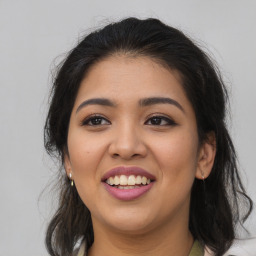 Joyful latino young-adult female with long  brown hair and brown eyes