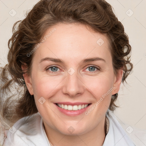 Joyful white adult female with medium  brown hair and blue eyes