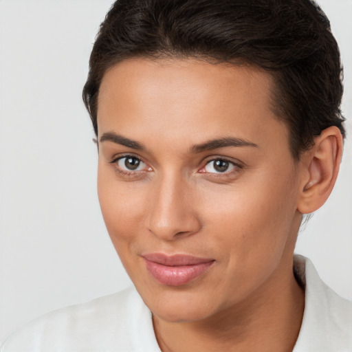 Joyful white young-adult female with short  brown hair and brown eyes