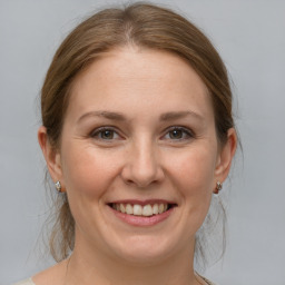 Joyful white adult female with medium  brown hair and grey eyes