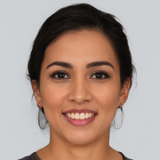 Joyful latino young-adult female with medium  black hair and brown eyes