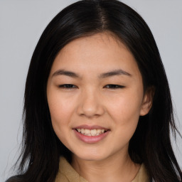 Joyful asian young-adult female with long  brown hair and brown eyes