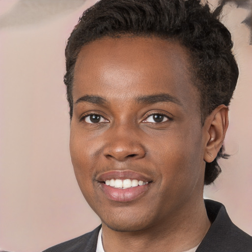 Joyful black young-adult male with short  brown hair and brown eyes