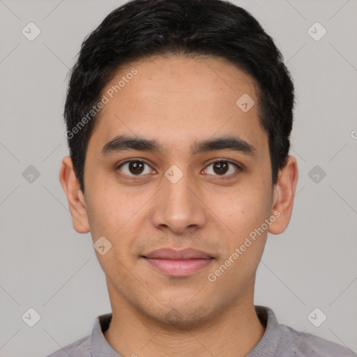 Joyful latino young-adult male with short  black hair and brown eyes