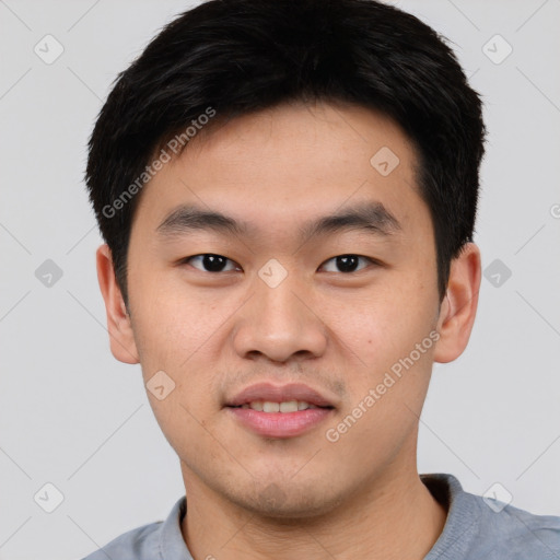 Joyful asian young-adult male with short  black hair and brown eyes