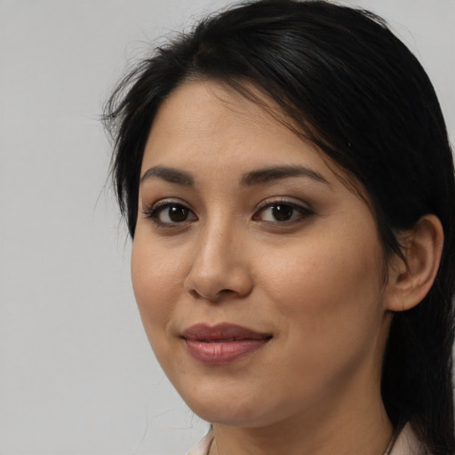 Joyful latino young-adult female with medium  black hair and brown eyes