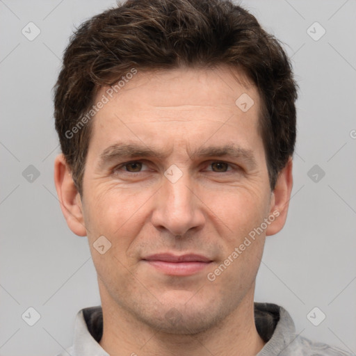 Joyful white adult male with short  brown hair and grey eyes