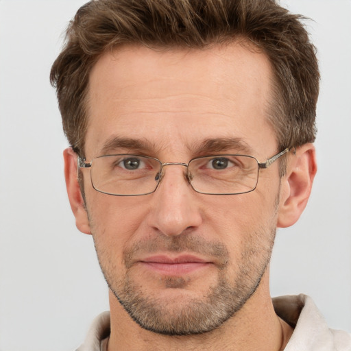 Joyful white adult male with short  brown hair and brown eyes