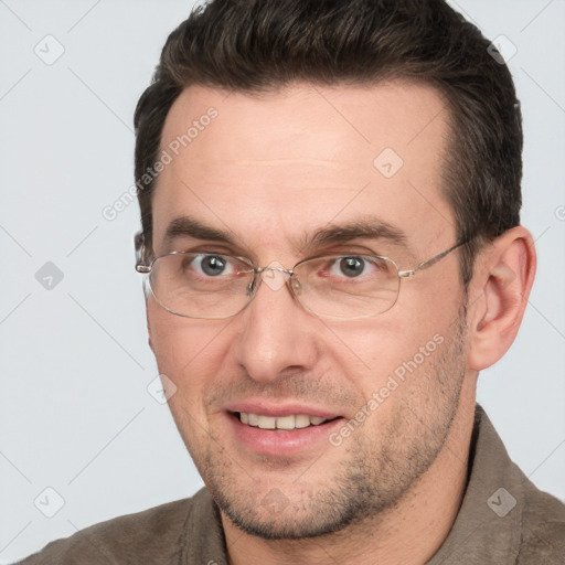 Joyful white adult male with short  brown hair and brown eyes