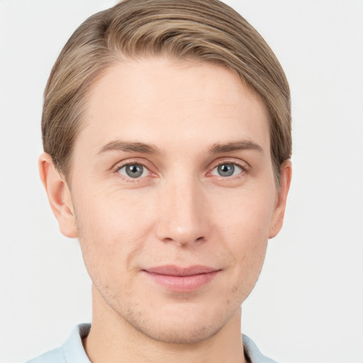 Joyful white young-adult male with short  brown hair and grey eyes