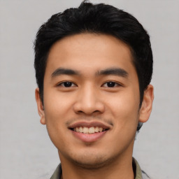 Joyful asian young-adult male with short  black hair and brown eyes