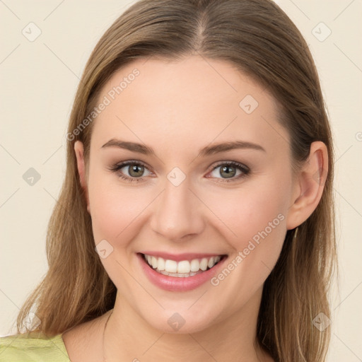 Joyful white young-adult female with long  brown hair and green eyes