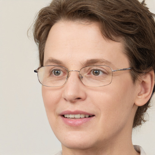 Joyful white adult female with medium  brown hair and green eyes