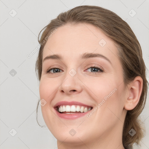 Joyful white young-adult female with medium  brown hair and blue eyes