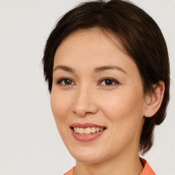 Joyful white young-adult female with medium  brown hair and brown eyes