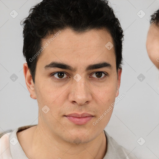 Joyful latino young-adult male with short  brown hair and brown eyes