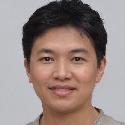 Joyful asian young-adult male with short  black hair and brown eyes