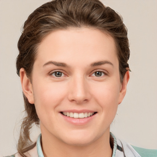 Joyful white young-adult female with short  brown hair and grey eyes