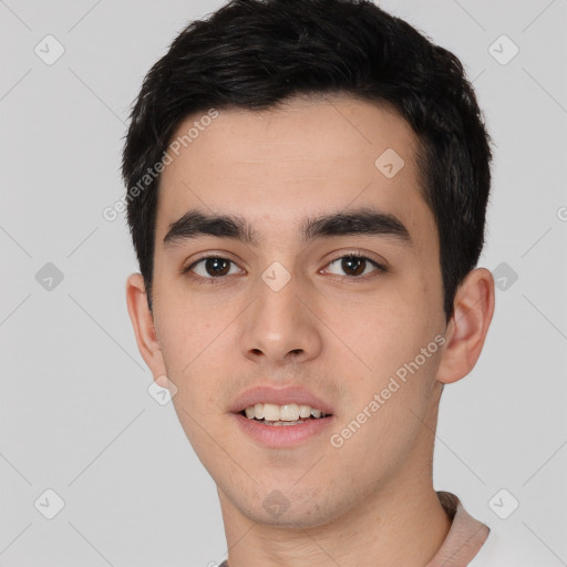 Joyful white young-adult male with short  black hair and brown eyes