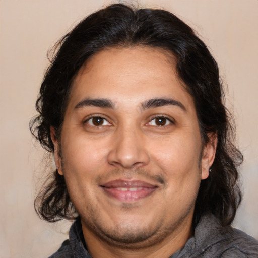 Joyful white adult male with medium  brown hair and brown eyes