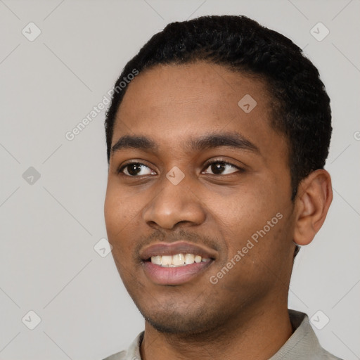 Joyful black young-adult male with short  black hair and brown eyes