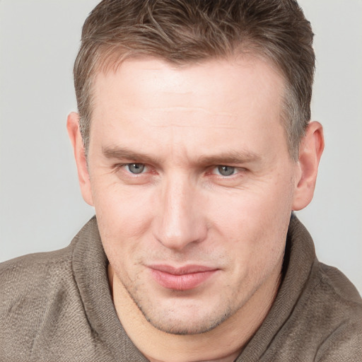 Joyful white adult male with short  brown hair and grey eyes