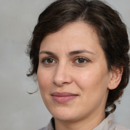 Joyful white adult female with medium  brown hair and brown eyes