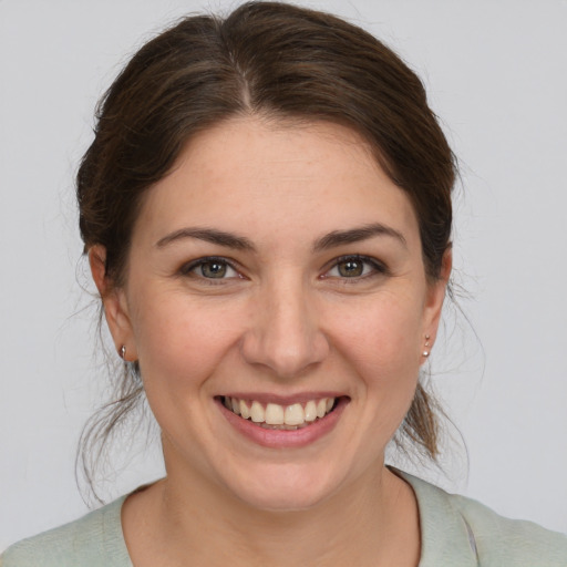 Joyful white young-adult female with medium  brown hair and brown eyes