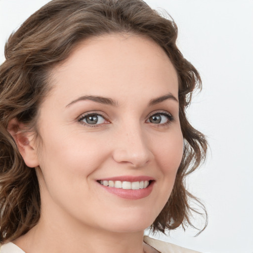 Joyful white young-adult female with medium  brown hair and green eyes