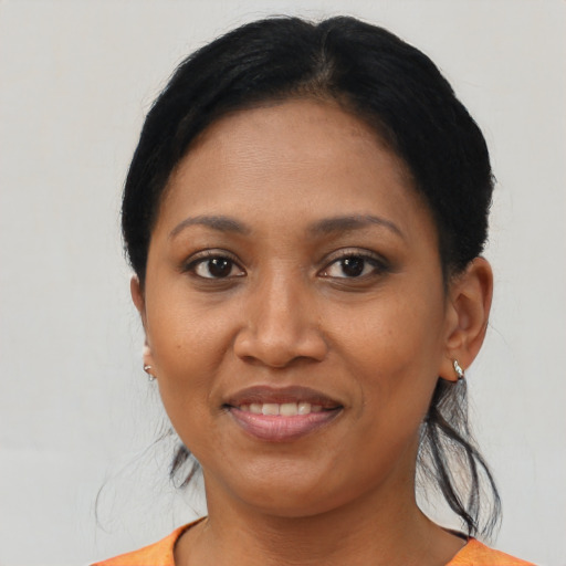 Joyful latino adult female with short  black hair and brown eyes