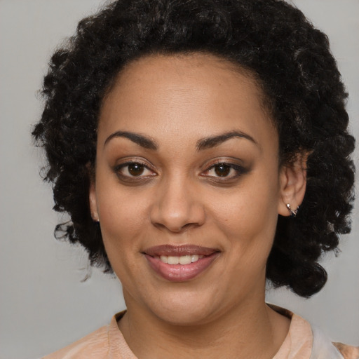 Joyful black young-adult female with medium  black hair and brown eyes