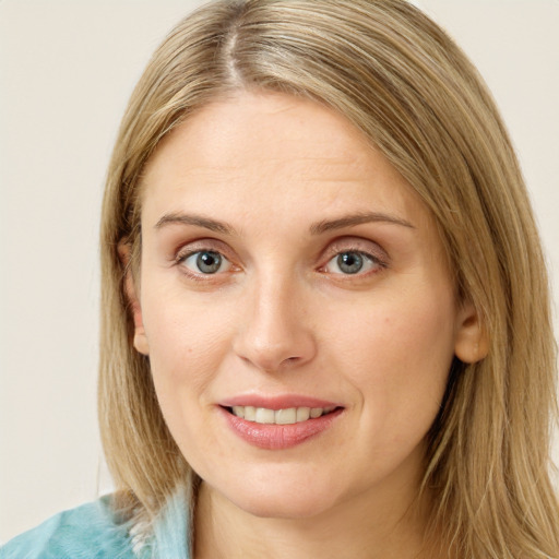 Joyful white young-adult female with medium  brown hair and blue eyes