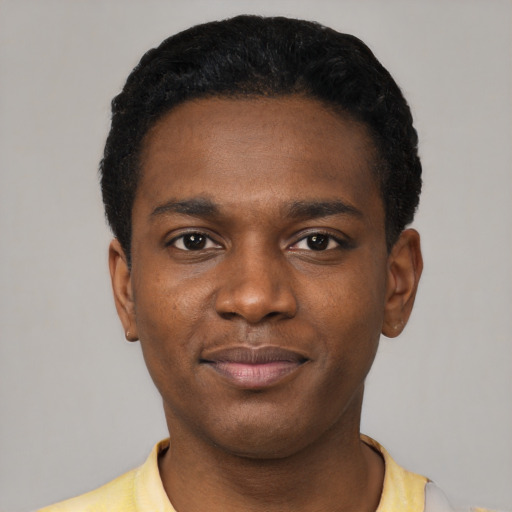 Joyful black young-adult male with short  black hair and brown eyes