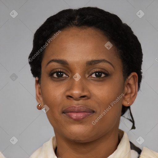 Joyful black young-adult female with short  black hair and brown eyes