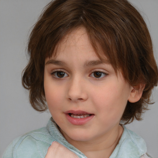 Joyful white child female with medium  brown hair and brown eyes