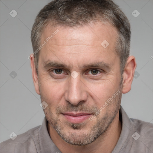 Joyful white adult male with short  brown hair and brown eyes