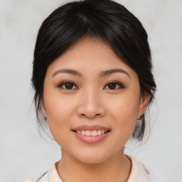 Joyful asian young-adult female with medium  brown hair and brown eyes