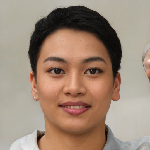 Joyful asian young-adult female with short  black hair and brown eyes